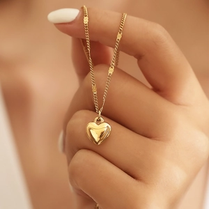Polished gold heart pendant necklace for women featuring a minimalist titanium steel chain