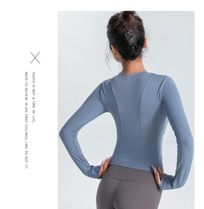 Détail des coutures incurvées ergonomiques au dos de ce haut de sport bleu-gris ajusté