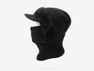 Side view of black knitted balaclava featuring faux fur ear flaps and a protective visor