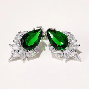 Macro detail of pear-cut green gemstone earrings with marquise-cut zirconia flower cluster