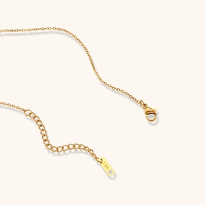 Detail of adjustable gold necklace chain with 18K hallmark tag and lobster clasp