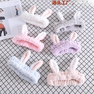 Detail of coral fleece headbands in six pastel colors featuring plush rabbit ear design