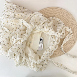 Close-up of floral tote bag interior with yellow lining and functional zipper pocket