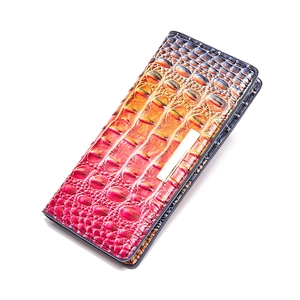 Detail of gradient crocodile embossed wallet showing luxury texture and metal hardware