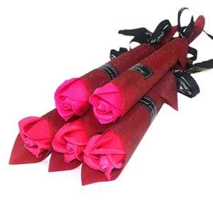 Five magenta soap roses in dark red glitter wrapping paper with gift ribbons