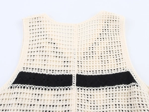 Close-up of crochet knit hollow pattern and textures on the vintage tassel vest