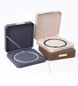 Octagonal jewelry boxes in velvet finish showing premium necklace sets and gold logo