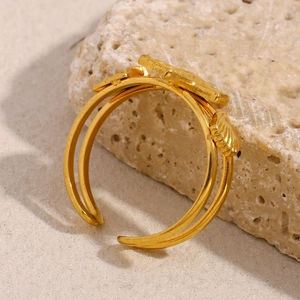 Macro detail of 18K gold starfish open ring showing sea shell texture and dual band