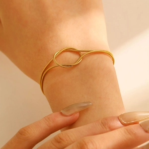 Minimalist gold snake chain bracelet featuring a stylish knot design for couples