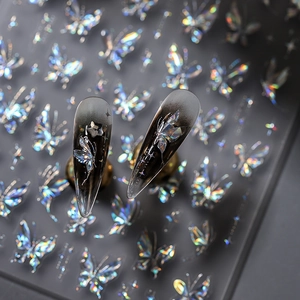 Holographic butterfly nail stickers on dark gradient long pointed nails for edgy style