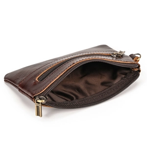 Detail view of double zipper compartments on a vintage dark brown leather coin purse