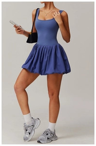 Detail of blue tennis dress with ruffled hem and square neck for athletic performance