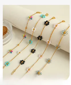 Detail of five colorful beaded flower charm bracelets on a jewelry display stand