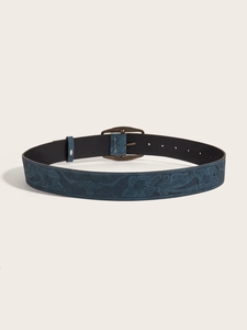 Detail of dark blue vintage Y2K leather belt featuring embossed floral and bull head patterns