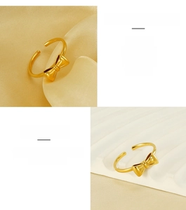 Detailed view of adjustable 18K gold plated bow ring in premium stainless steel