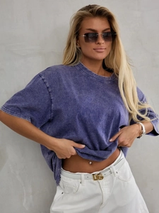 Close-up of vintage purple acid wash t-shirt showing oversized fit and cotton texture