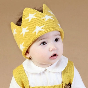 Knitted baby crown hat with white stars and matching overalls for infants