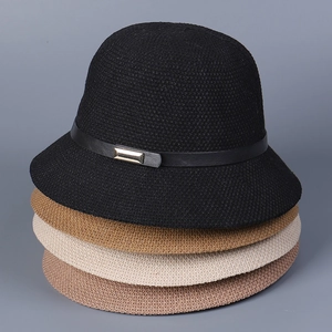 Close-up of four knitted bucket hats in neutral tones with elegant metal buckle detail