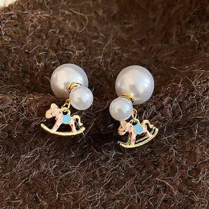 Elegant silver needle double pearl earrings with pink enamel rocking horse charm drop