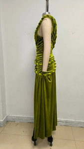 Close-up of green velvet dress featuring braided knot edge and ruched design detail