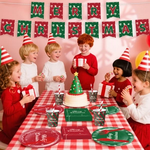 Kids enjoying a Christmas party with festive paper plates, cups, and napkins