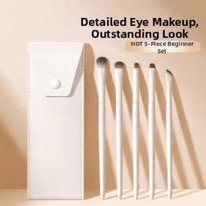 Close-up of 5-piece eye makeup brush set with beige leather pouch and fiber bristles