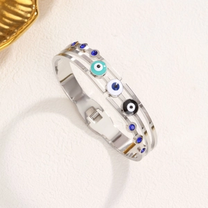 Vintage stainless steel devil's eye bangle with colorful enamel and blue rhinestones