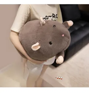 Detailed close-up of the soft grey plush mouse toy held by a model in a home setting