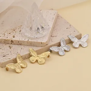Elegant butterfly titanium steel stud earrings in gold and silver finish on stone