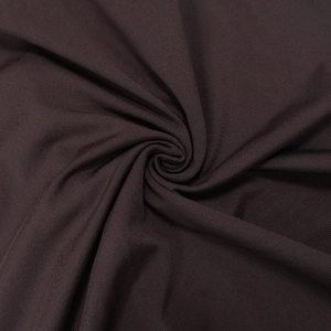 Macro shot of dark brown gathered dress fabric with fine twill texture and soft elasticity