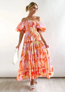 Detailed close-up of smocked bodice and puff sleeves on a floral off-shoulder summer dress