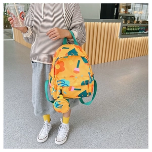Detail view of yellow floral kids backpack with matching coin purse and side pocket