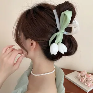 Elegant green satin bow hair claw clip with white tulips and pearl necklace view