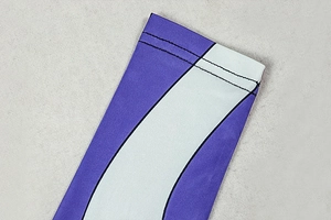 Detailed macro view of purple and white striped fabric stitching on a fitted dress