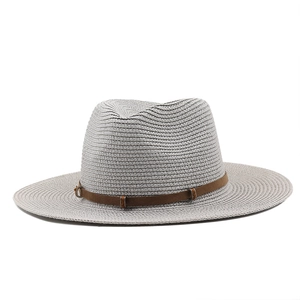 Detail of grey woven straw cowboy hat with a brown decorative band and metal buckle