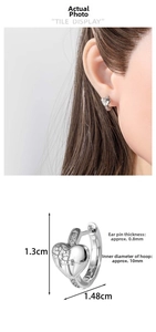 Detailed view of silver heart huggie earring with floral relief and size dimensions