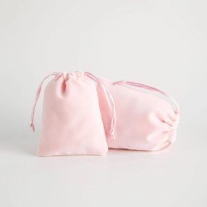 Pink velvet drawstring jewelry pouches on white background for gift packaging