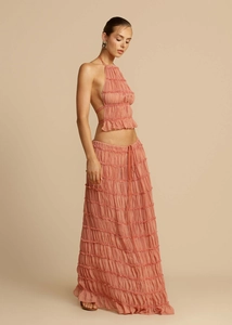 Detail view of pink-orange pleated halter top and long skirt set with delicate texture