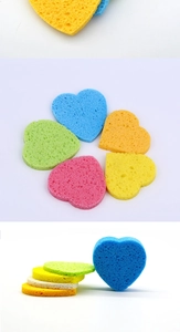 Detailed view of colorful heart-shaped compressed wood pulp sponges for facial cleaning