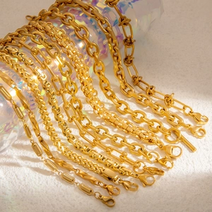 Detailed macro view of 18k gold plated paperclip and twisted chain bracelets