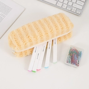 Macro shot of light yellow striped plush fabric texture and metallic zipper on pencil case