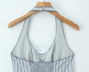Detail of blue and white striped halter dress with elastic smocked back on wooden hanger