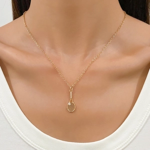 Polished gold tennis racket necklace with a single zircon stone on a classic O-chain link