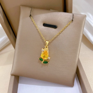 Detail of rosebud necklace with champagne yellow gemstone and green leaf accents