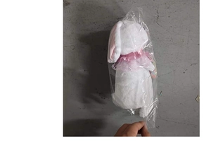 Detail showing a white glowing plush bunny toy in clear packaging for Easter gifts