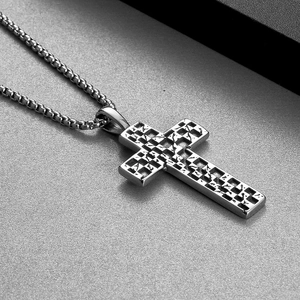 Detailed macro shot of vintage silver cross pendant with punk checkered texture pattern