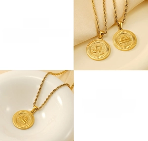 Detailed close-up of 18k gold-plated stainless steel zodiac coin necklace with rope chain