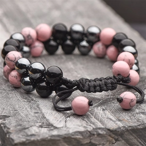 Macro detail of 8mm pink turquoise and black hematite beads on double-layer woven bracelet