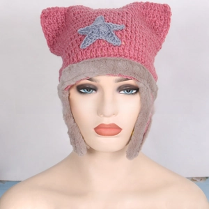 Detail of pink knitted cat ear hat with gray star patch and soft faux fur ear flaps