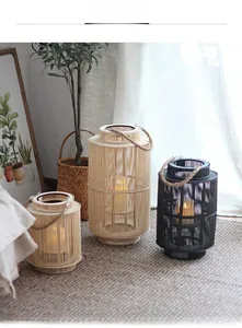 Detail of hand-woven lanterns with rope handles and flickering LED candles inside